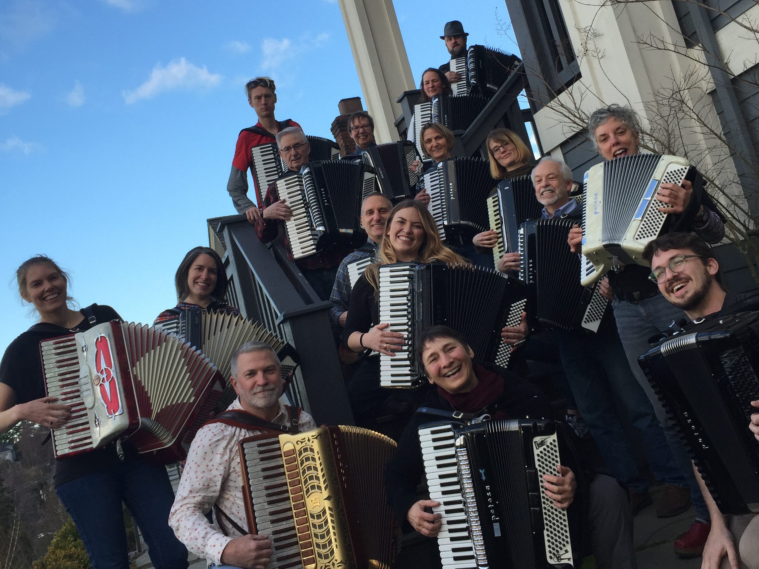 Emerald City Accordion students gathered with their accordions on outdoor stairs in Seattle